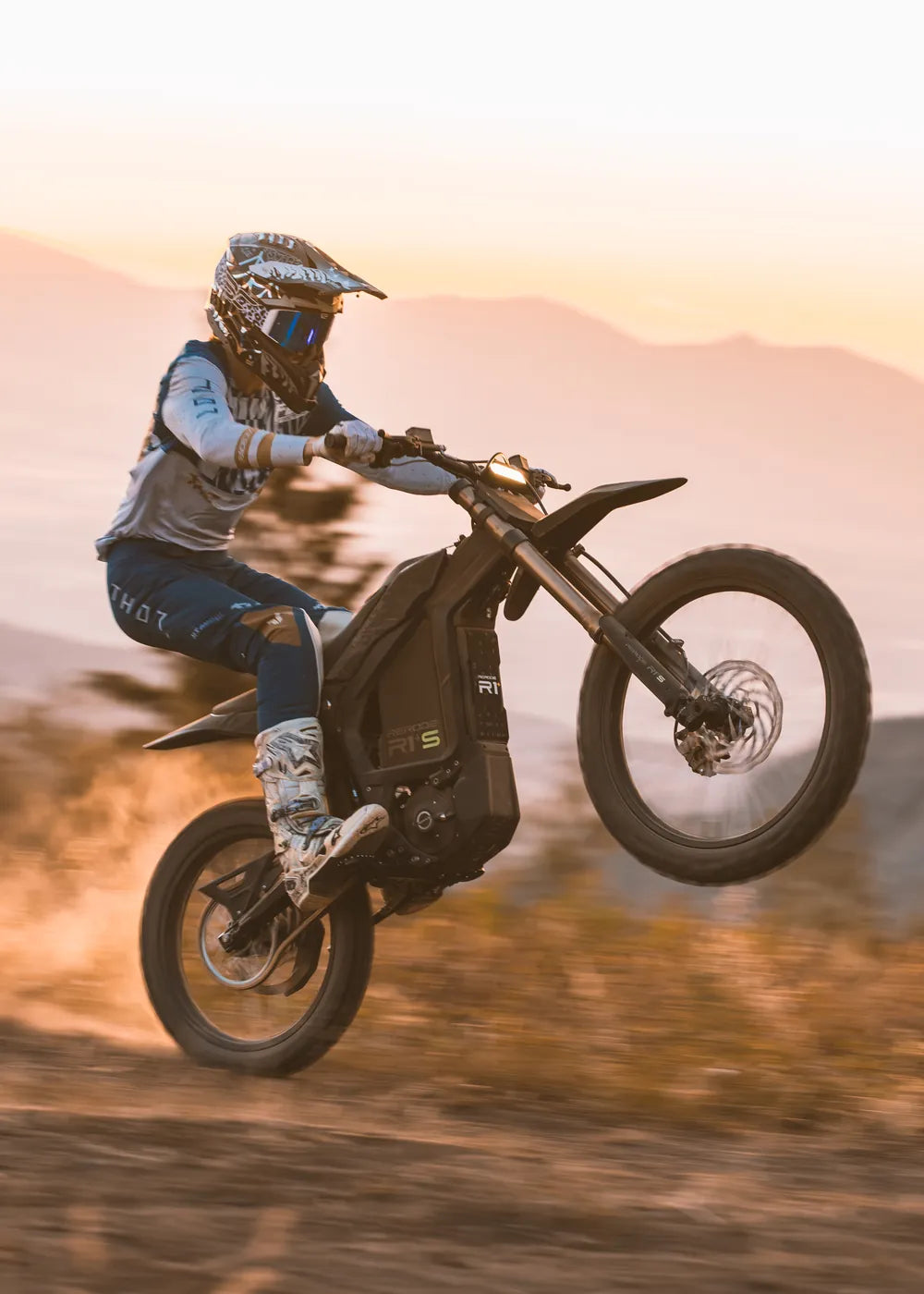 Rider wheelieing a Rerode R1+S at sunset