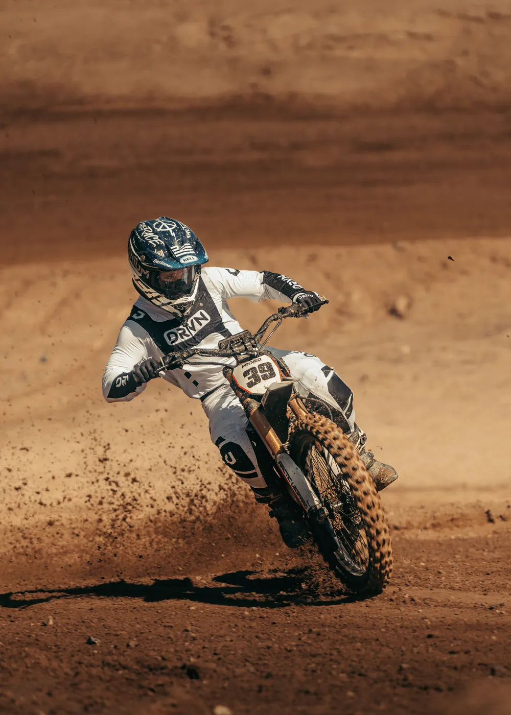 Pinned Electric factory rider #39 cornering on an Arctic Leopard